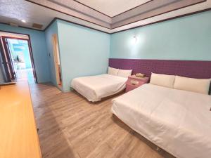 Postel nebo postele na pokoji v ubytování 大潭山莊 Da Tan Mountain INN