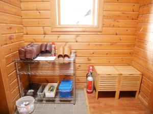 a sauna with wooden walls and a window and a shelf at Niseko Forest Villa - Cottage with sauna in Niseko