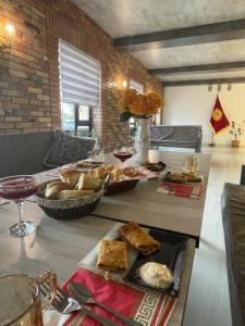 a table with a bunch of food on it at Irbis Hostel in Karakol +33 photos