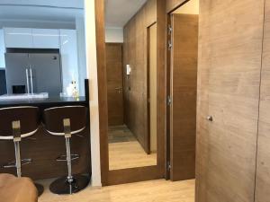 a kitchen with two stools and a counter in a room at Luxury flat in Cervinia 34 in Breuil-Cervinia +12 photos