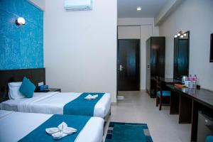 Krevet ili kreveti u jedinici u okviru objekta Tuki Resort Pokhara