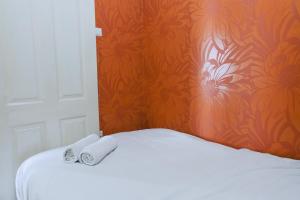 a bed with two rolled towels on top of it at Good Deal 2BR at 16th Floor Suites @Metro Apartment By Travelio in Bandung +5 photos