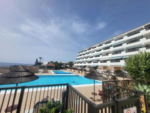 a hotel with a swimming pool with umbrellas at VILLA SISSI Atlantic View in Costa Del Silencio