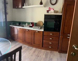 a kitchen with a sink and a tv on a counter at Casa dello Chef, Il loft nel cuore della città in Lecce +4 photos