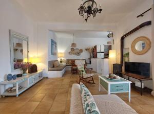 a living room with a couch and a table at Poros Pine View in Poros