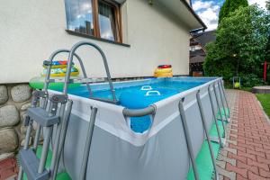 a swimming pool in a house with a swimming pool at Markowy Dworek in Białka Tatrzańska