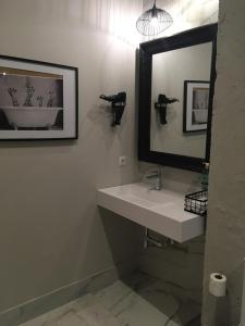 a bathroom with a sink and a mirror at Hacienda Soto-Hego Haizea in Chiclana de la Frontera