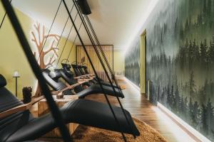 a gym with a bunch of exercise equipment at Hotel Eibl-Brunner 4-Sterne-Superior in Frauenau