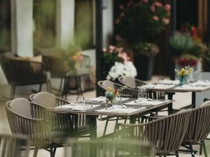 a group of tables and chairs with glasses on them at Hotel Eibl-Brunner 4-Sterne-Superior in Frauenau