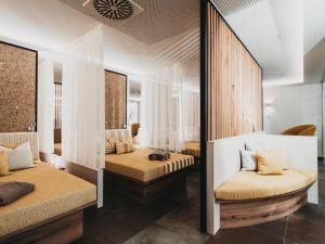 a bedroom with two beds and a mirror at Hotel Eibl-Brunner 4-Sterne-Superior in Frauenau +82 photos