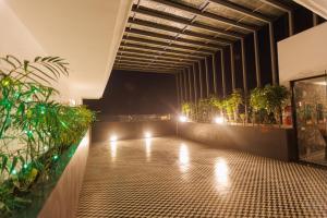 a room with potted plants and lights on the floor at Mannat Residency By iO Hotels Near Golden Temple in Amritsar