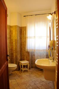een badkamer met een bad, een wastafel en een toilet bij La Casa Di Babbai in Nuchis
