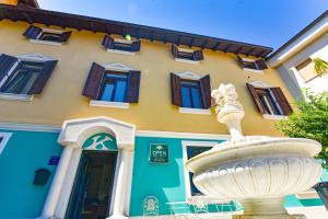 a building with a fountain in front of a building at Villa Kontesa in Lovran