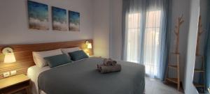 a bedroom with a bed with a towel on it at Parginaki House in Parga