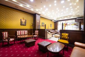 a waiting room with chairs and a table and chairs at Sveta Sofia Hotel in Sofia