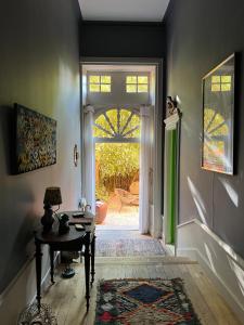 a hallway with a table and a door to a yard at Une Nuit Au Château in Lyon