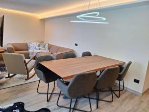 ein Esszimmer mit Tisch und Stühlen und einer Couch in der Unterkunft Appartamento elegante in centro Q434 in Breuil-Cervinia