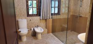 a bathroom with a toilet and a sink at Hantana Forest Reserve Inn in Kandy +26 photos