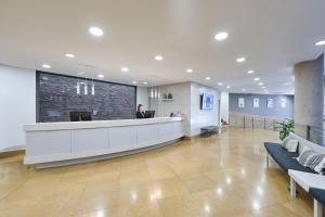 a man standing at a reception desk in a hospital lobby at Catalonia La Boquería in Barcelona