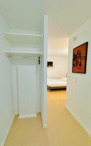 an empty room with a bed in the background at Diac Hotel L'Hermitte Bordeaux in Bordeaux +12 photos