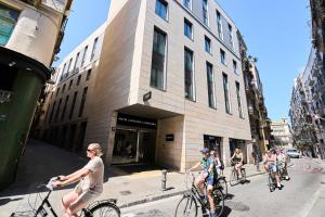 a group of people riding bikes down a city street at Catalonia La Boquería in Barcelona