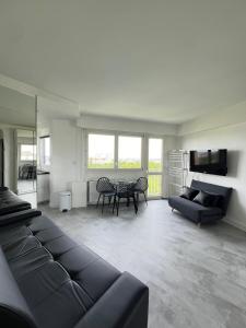 a living room with a couch and a table at Apartment HOME in Paris with View, 15min direct to center in Paris