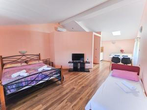 a bedroom with a bed and a fireplace at Villa Kontesa in Lovran