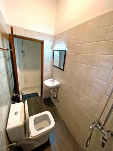 a bathroom with a toilet and a sink at Hotel Vish Ceylon in Talawatugoda +7 photos