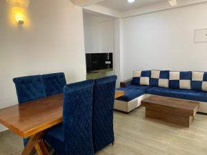a living room with a couch and a table and chairs at Hotel Vish Ceylon in Talawatugoda