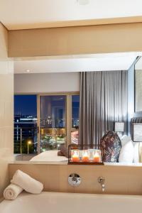 ケープタウンにあるHarbour's Edge Walk to V & A Waterfront and CTICCのベッドと大きな窓のある寝室