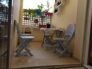 two chairs and a table in a room with a window at Nice apartment with nice view in El Aouina +6 photos