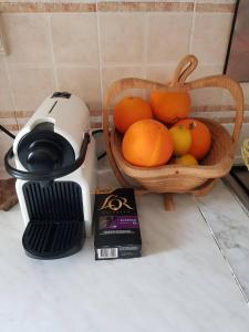 a basket of oranges on a counter next to a blender at Nice apartment with nice view in El Aouina