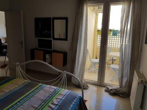 a bedroom with a bed and a sliding glass door at Nice apartment with nice view in El Aouina