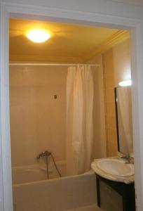 a bathroom with a sink and a tub and a toilet at Nice apartment with nice view in El Aouina