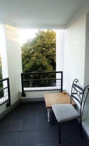 a balcony with a table and a bench and a window at Appartement de Luxe à Torcy in Torcy