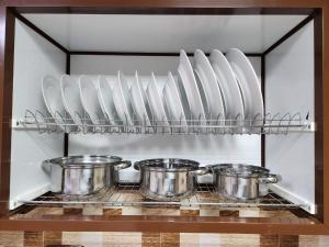a kitchen with pots and pans on a shelf at iQama 2 in Salalah