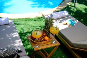 a tray of fruit and two glasses of orange juice at Aqua Verde Luxury Villa by Nomads in Protaras