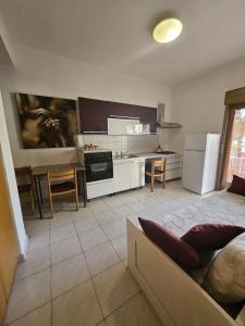 a kitchen with a couch and a table in it at Don Vladi in Letojanni