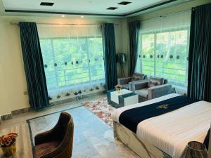 a bedroom with a bed and a living room at Hilton Resort Malamjabba by Khan Familia Travels in Malam Jabba
