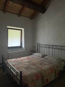 A bed or beds in a room at B&b Al Ciliegio Del Turchino