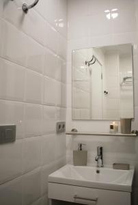 a white bathroom with a sink and a mirror at TC Lindamar in Las Palmas de Gran Canaria