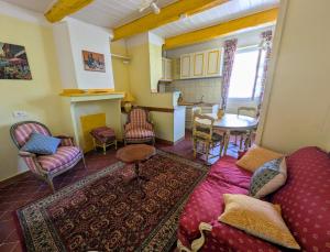 a living room with a couch and a table at Le Relais Laviolette in Cruis