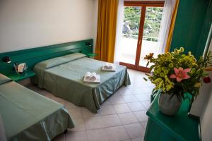 Postel nebo postele na pokoji v ubytování Hotel Miralonga