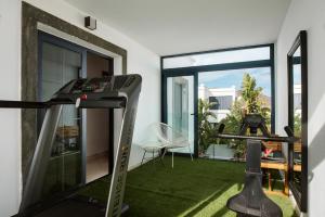 a fitness room with a treadmill and a balcony at Villa Acacia in Yaiza