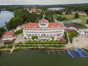 an aerial view of a large white building with a red roof at Hotel Woiński Spa in Lubniewice