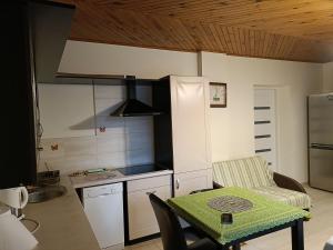 a kitchen with a table and a small kitchen with a table and a chair at apartament blisko Energylandii in Zator
