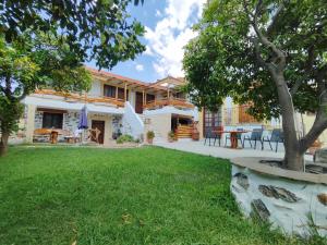 a house with a lawn in front of it at Orange Garden Loft in Kala Nera
