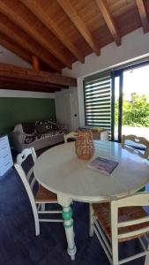 a dining room with a table and chairs and a couch at Lake in Nature in Consiglio di Rumo