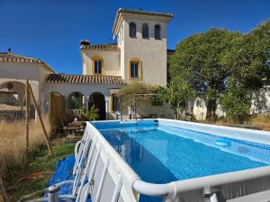 a swimming pool in front of a house at AA Guest - Trevenque del Jardín de Sierra Nevada in Alhendín