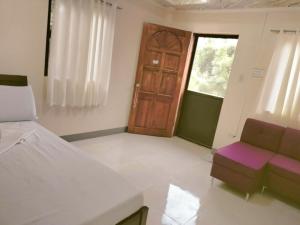 Ένα ή περισσότερα κρεβάτια σε δωμάτιο στο Samara's Guests House